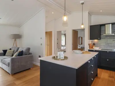 a kitchen and living room with a large island at The Yews in Ulverston