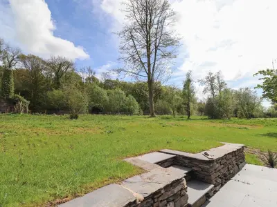a stone bench in the middle of a field at The Yews in Ulverston