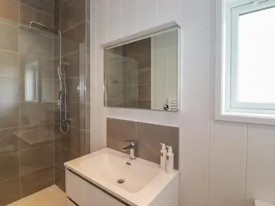 a bathroom with a sink and a shower and a mirror at The Yews in Ulverston