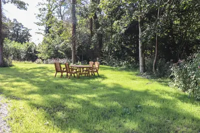 a picnic table and chairs in a field of grass at The Burrow in Ulverston