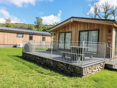 a mobile home with a porch and a fence at The Burrow in Ulverston