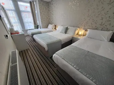 a hotel room with two beds and a window at The Lumada in Blackpool