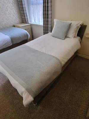 a bedroom with two beds and a window at The Lumada in Blackpool