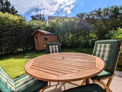 a wooden table with two chairs and a bird house at Double Room l Large TV l Great Transport Links in Bolton