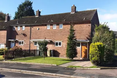 a brown brick house with a black roof at Double Room l Large TV l Great Transport Links in Bolton
