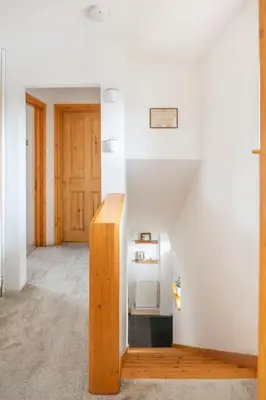 a hallway with white walls and a wooden door at Double Room l Large TV l Great Transport Links in Bolton