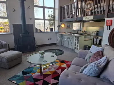 a living room with a couch and a table at The Dairy at Brackenthwaite Farm in Carnforth