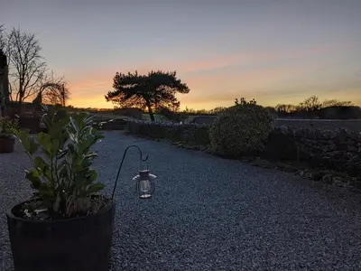 a lantern sitting on the ground next to a plant at The Dairy at Brackenthwaite Farm in Carnforth