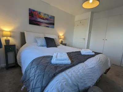 a bedroom with a bed with two towels on it at Corner Cottage at Brackenthwaite Farm in Carnforth