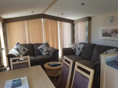 a living room with a couch and a table at 6 berth holiday home on Ocean Edge near Morecambe in Heysham