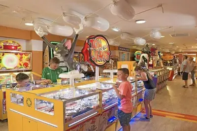 a group of children playing at a pinball game at 6 berth holiday home on Ocean Edge near Morecambe in Heysham