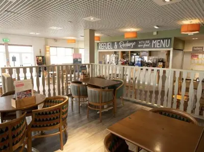 a dining room with wooden tables and chairs in a restaurant at 6 berth holiday home on Ocean Edge near Morecambe in Heysham