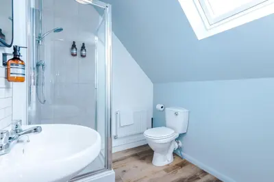 a bathroom with a toilet and a sink and a shower at Newly Refurbished 3 Double Bedroom Knowsley Liverpool Townhouse in Knowsley