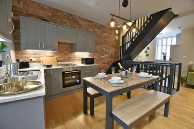 a kitchen and dining room with a table and chairs at Quirky cottage set in Clitheroe in Clitheroe