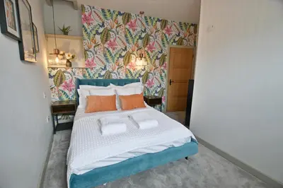 a bedroom with a bed with orange and white pillows at Quirky cottage set in Clitheroe in Clitheroe