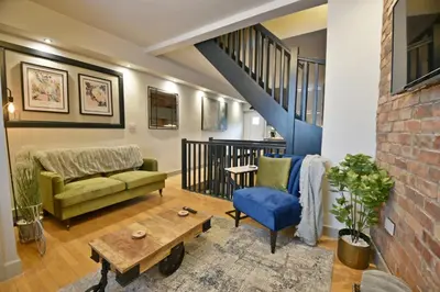 a living room with a couch and a table at Quirky cottage set in Clitheroe in Clitheroe