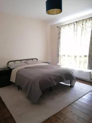 a bedroom with a bed and a window at Miller's Cottage in Lancaster in Lancaster