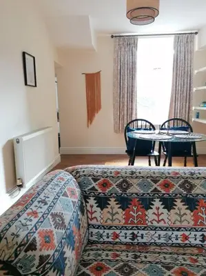 a room with a bed and a table and a couch at Miller's Cottage in Lancaster in Lancaster