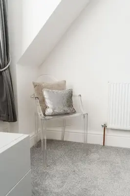 a chair with a pillow on it in a room at Birkby Lodge Escape in Lytham St Annes