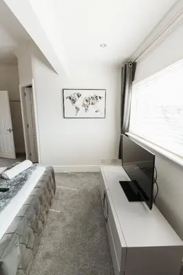 a bedroom with a bed and a window at Birkby Lodge Escape in Lytham St Annes