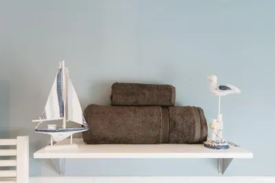 a pile of towels sitting on a shelf with a lamp at Birkby Lodge Escape in Lytham St Annes