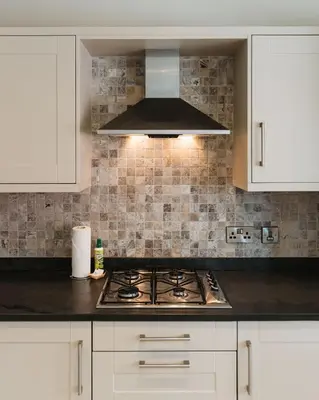 a kitchen with white cabinets and a stove top oven at Birkby Lodge Escape in Lytham St Annes