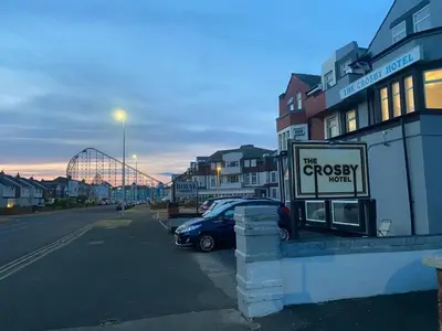 a sign for a grocery store on the side of a street at Crosby Hotel in Blackpool