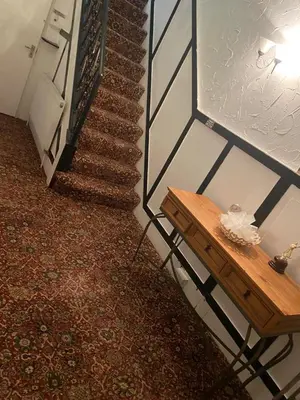 a stairway with a wooden table next to a staircase at Crosby Hotel in Blackpool