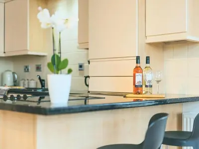 a kitchen with a counter with two bottles of wine at Baltic Dockside Apartment, Free Parking in Liverpool