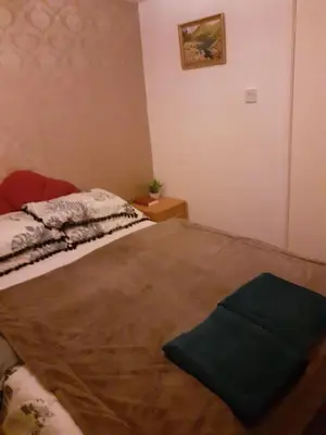 a bedroom with a bed with a green pillow on it at Lynwood Hotel & Spa in Blackpool