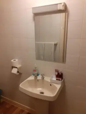 a white sink in a bathroom with a mirror at Lynwood Hotel & Spa in Blackpool