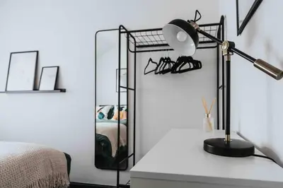 a lamp sitting on a table next to a bedroom at 10Min Walk to Stadium SofaBed WM & Dishwasher in Liverpool