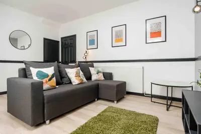 a living room with a couch and a table at 10Min Walk to Stadium SofaBed WM & Dishwasher in Liverpool