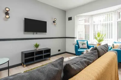 a living room with a couch and a flat screen tv at 10Min Walk to Stadium SofaBed WM & Dishwasher in Liverpool