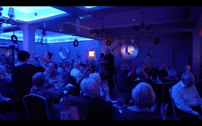 a group of people sitting in a room at The Royal Boston Hotel by Compass Hospitality in Blackpool