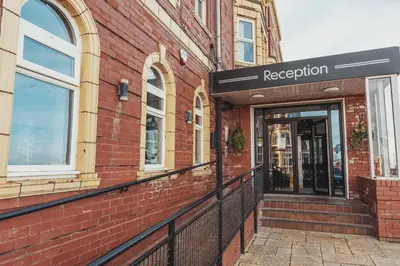 a red brick building with a registration sign on it at The Royal Boston Hotel by Compass Hospitality in Blackpool