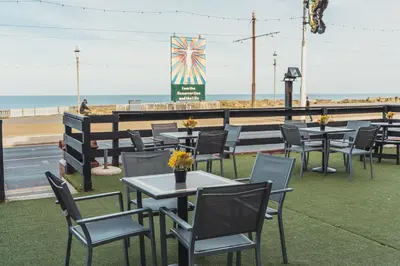 a row of tables and chairs at a restaurant on the beach at The Royal Boston Hotel by Compass Hospitality in Blackpool