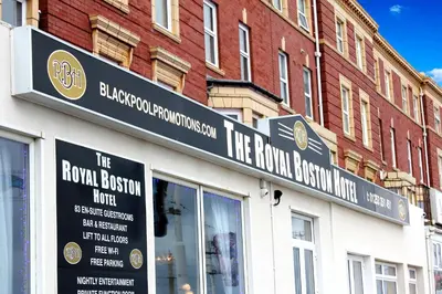a building with a sign on the front of a store at The Royal Boston Hotel by Compass Hospitality in Blackpool