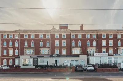 a large brick building with cars parked in front of it at The Royal Boston Hotel by Compass Hospitality in Blackpool