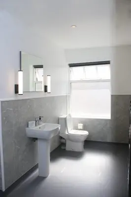 a white bathroom with a sink and a toilet at Fenwick Sunrise Hotel in Liverpool