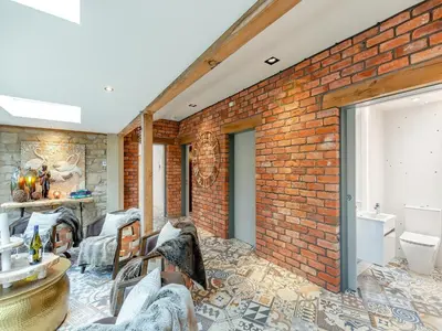 a living room with a brick wall at The Stables in Longridge