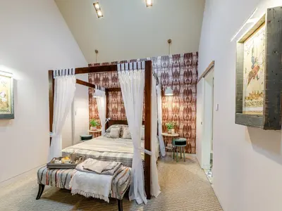 a bedroom with a canopy bed and a table at The Stables in Longridge