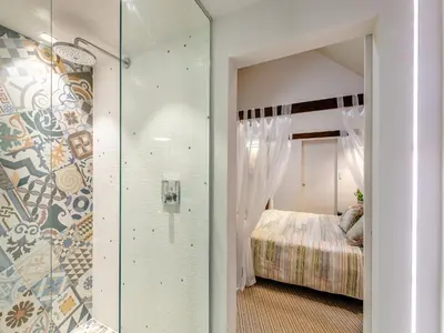 a bedroom with a glass door leading to a bed at The Stables in Longridge