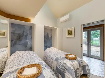 a bedroom with two beds and a mirror at The Stables in Longridge