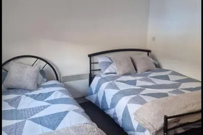 two beds sitting next to each other in a bedroom at Apt - Sleeps 7 - Walking Distance to Attractions in Liverpool