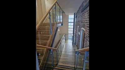a staircase with glass railings and a brick wall at Apt - Sleeps 7 - Walking Distance to Attractions in Liverpool