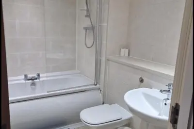 a bathroom with a tub and a toilet and a sink at Apt - Sleeps 7 - Walking Distance to Attractions in Liverpool