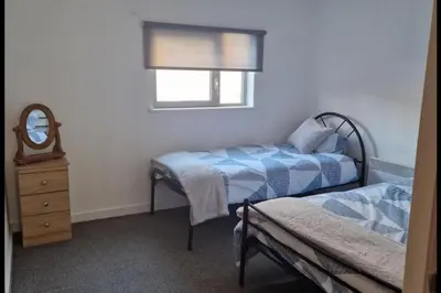 a bedroom with two beds and a mirror and a dresser at Apt - Sleeps 7 - Walking Distance to Attractions in Liverpool