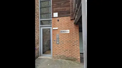 a door on the side of a brick building at Apt - Sleeps 7 - Walking Distance to Attractions in Liverpool