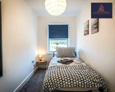 a small bedroom with a bed and a window at Swan House Apartment 7 - 2 Bed Apartment - Sleeps 5 - Free Parking - Liverpool - close to city centre - By ALL ELITE STAYS in Liverpool